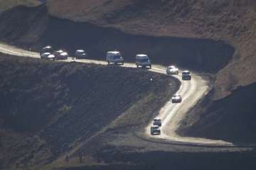 Cars with people leaving the separatist region of Nagorno-Karabakh to Armenia approach the border of
