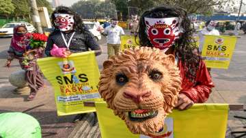 Volunteers, wearing masks, participate in a COVID-19 awareness campaign as coronavirus cases rise ac