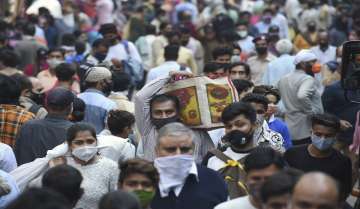 Shoppers visit a crowded Baratooti Bazar during 'Dhanteras' festival on the eve of 'Diwali', amid the ongoing coronavirus pandemic in New Delhi.