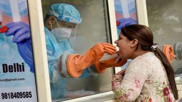  A health worker collects swab sample for the COVID-19 test, at IIT Delhi in New Delhi,