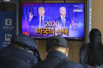 A TV screen shows images of U.S. President Donald Trump, left, and Democratic presidential candidate