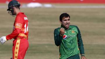 Pakistani spinner Iftikhar Ahmed, right, celebrates after taking the wicket of Zimbabwe's batsman Tendai Chisoro during their 2nd one-day international cricket match at the Pindi Cricket Stadium, in Rawalpindi, Pakistan, Sunday, Nov. 1