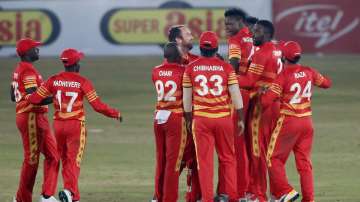 Zimbabwe's pacer Blessing Muzarabani, third right, celebrates with teammates after taking the wicket of Pakistani batsman Babar Azam during the 3rd one-day international cricket match at the Pindi Cricket Stadium, in Rawalpindi, Pakistan, Tuesday, Nov. 3