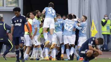 Lazio's Felipe Caicedo, covered by his teammates, celebrates after scoring his side's opening goal during the Serie A soccer match between Lazio and Juventus at the Olympic stadium in Rome, Sunday, Nov. 8