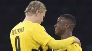 Dortmund's Erling Haaland, left, and Youssoufa Moukoko hug each other after the end of the game a German Bundesliga soccer match between Hertha BSC Berlin and Borussia Dortmund in Berlin, Geremany, Saturday, Nov.21