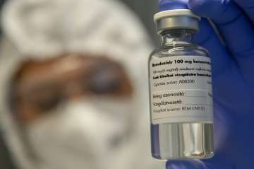 A bottle containing the drug Remdesivir is held by a health worker at the Institute of Infectology o