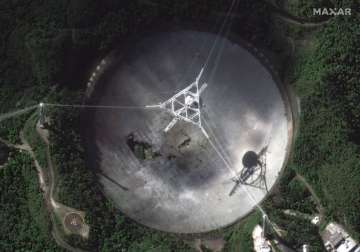 This satellite image provided by 2020 Maxar Technologies shows the damaged radio telescope at the Arecibo Observatory in Puerto Rico, Thursday, Nov. 17, 2020. The National Science Foundation announced Thursday, Nov. 17 that it will close the huge telescope in a blow to scientists worldwide who depend on it to search for planets, asteroids and extraterrestrial life, saying it’s too dangerous to keep operating the single-dish radio telescope because the entire structure could collapse.