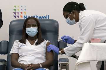 Sandra Lindsay, left, a nurse at Long Island Jewish Medical Center, is inoculated with the Pfizer-BioNTech COVID-19 vaccine by Dr. Michelle Chester, Monday, Dec. 14, 2020, in the Queens borough of New York. 
 