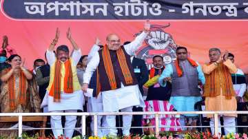 Union Home Minister Amit Shah waves at his supporters during an election rally ahead of West Bengal Assembly polls 2021, in West Midnapore district, Saturday, December 19, 2020.