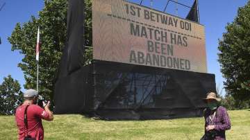 A board announces Sunday, Dec. 6, 2020, that the first ODI cricket match between England and South Africa at Boland Park in Paarl, South Africa has been abandoned due to a COVID-19 scare. The match had been postponed from Friday to Sunday and shifted from Cape Town to Paarl