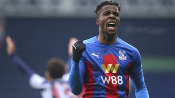 Crystal Palace's Wilfried Zaha celebrates after his shot is turned in by West Bromwich Albion's Darnell Furlong for the first goal during the English Premier League soccer match between West Bromwich Albion and Crystal Palace at the Hawthorns, West Bromwich, England, Sunday, Dec. 6