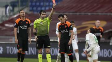 Roma's Pedro, centre, is shown the red card by the referee after a foul on Sassuolo's Maxime Lopez, right, during a Serie A soccer match between Roma and Sassuolo at the Olympic Stadium in Rome, Italy, Sunday, Dec. 6