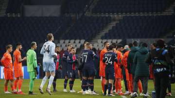 Players of Paris Saint Germain, and Istanbul Basaksehir leave the pitch, during the Champions League group H soccer match between Paris Saint Germain and Istanbul Basaksehir at the Parc des Princes stadium in Paris, Tuesday Dec. 8