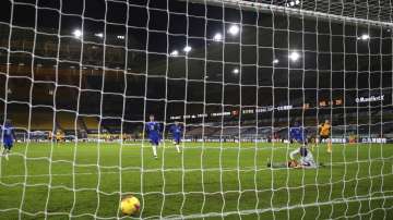 Wolverhampton Wanderers' Pedro Neto, right, scores against Chelsea during the English Premier League soccer match between Wolverhampton Wanderers and Chelsea at the Molineux Stadium in Wolverhampton, England, Tuesday, Dec. 15