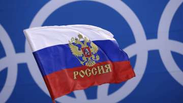 In this Saturday, Feb. 17, 2018 file photo Russian supporter waves a flag before the preliminary round of the men's hockey game between the team from Russia and the United States at the 2018 Winter Olympics in Gangneung, South Korea. Russia was banned Thursday Dec. 17