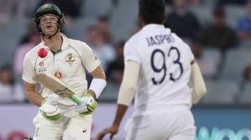 Australia's Tim Paine, left, plays a delivery from India's Jasprit Bumrah, right, on the second day of their cricket test match at the Adelaide Oval in Adelaide, Australia, Friday, Dec. 18