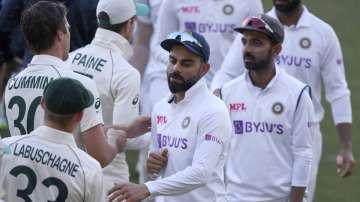 India's Virat Kohli, center, shakes hands with Australian players on the third day of their cricket test match at the Adelaide Oval in Adelaide, Australia, Saturday, Dec. 19, 2020. Australia won the match.
