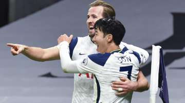 Tottenham's Son Heung-min, right, who scored his side's first goal, celebrates with Tottenham's Harry Kane, left, who scored his side's second goal, during the English Premier League soccer match between Tottenham Hotspur and Arsenal at Tottenham Hotspur Stadium in London, England, Sunday, Dec. 6