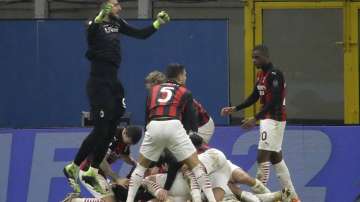 AC Milan players celebrate the third goal against Lazio form their teammate Theo Hernandez during a Serie A soccer match between AC Milan and Lazio, at the San Siro stadium in Milan, Italy, Wednesday, Dec. 23