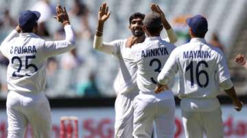 India's Jasprit Bumrah, centre, is congratulated by teammates after taking the wicket of Australia's Joe Burns for no score during play on day one of the Boxing Day cricket test between India and Australia at the Melbourne Cricket Ground, Melbourne, Australia, Saturday, Dec. 26