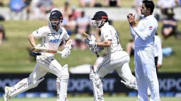 New Zealand batsmen Kane Williamson, left, and Henry Nicholls take a run during play on day two of the first cricket test between Pakistan and New Zealand at Bay Oval, Mount Maunganui, New Zealand, Sunday