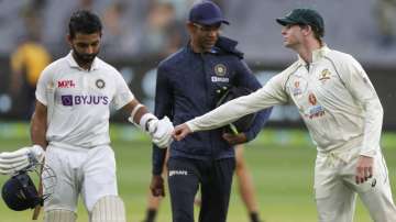 India's Ajinkya Rahane, left, is congratulated by Australia's Steve Smith as they leave the field at the close of play on day two of the second cricket test between India and Australia at the Melbourne Cricket Ground, Melbourne, Australia, Sunday, Dec. 27
