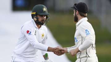 New Zealand captain Kane Williamson, right, congratulates Pakistan's Faheem Ashraf at the end of play after he scored 91 runs on day three of the first cricket test between Pakistan and New Zealand at Bay Oval, Mount Maunganui, New Zealand, Monday, Dec. 28