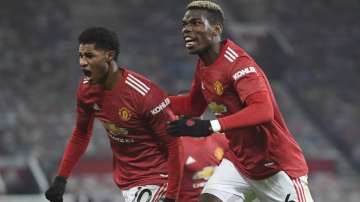 Manchester United's Marcus Rashford, left, celebrates with Paul Pogba after scoring the opening goal during the English Premier League soccer match between Manchester Utd and Wolverhampton Wanderers at Old Trafford stadium in Manchester, England, Tuesday,Dec. 29