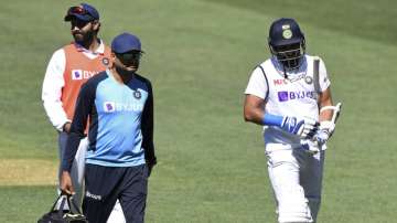 India's Mohammed Shami, right, retires hurt after he was struck on the forearm on the third day of their cricket test match against Australia at the Adelaide Oval in Adelaide, Australia, Saturday, Dec. 19