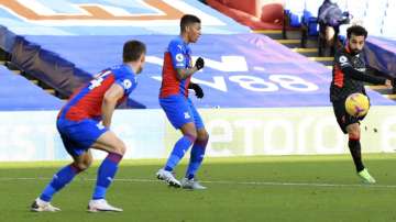 Liverpool's Mohamed Salah, right, scores his side's seventh goal during the English Premier League soccer match between Crystal Palace and Liverpool at Selhurst Park stadium in London, Saturday, Dec. 19