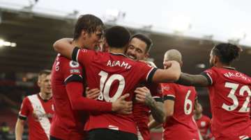 Southampton's Che Adams celebrates with his teammate Jannik Vestergaard, left and Danny Ings after scoring his side's opening goal during the English Premier League soccer match between Southampton and Sheffield United, at St. Mary's stadium in Southampton, England, Saturday, Dec. 13