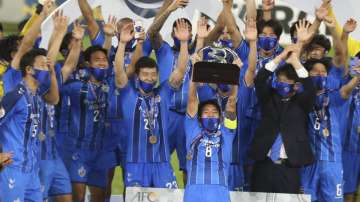 Ulsan Hyundai's players celebrate with a trophy after the AFC Champions League final match against Persepolis in Al Wakrah, Qatar, Saturday, Dec. 19, 2020.