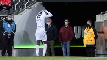 Moenchengladbach's Marcus Thuram leaves the pitch after getting a red card during their German Bundesliga soccer match between Borussia Moenchengladbach and 1899 Hoffenheim at Borussia-Park in Moenchengladbach, Germany, Saturday, Dec. 19