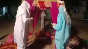 Rajasthan couple gets married in PPE kits after bride tests Covid positive on wedding day | WATCH
