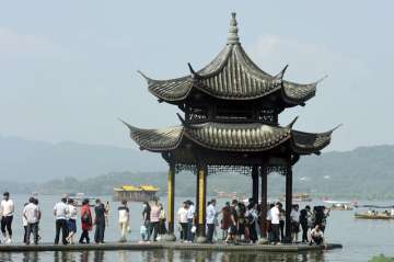 Tourists gather at a waterfront pavilion at the West Lake in Hangzhou in eastern China's Zhejiang Pr