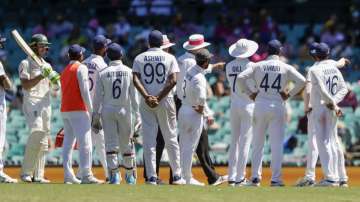 Australia's Tim Paine, left, waits as Indian players talk with the umpires over an issue with the crowd during play on day four of the third cricket test between India and Australia at the Sydney Cricket Ground, Sydney, Australia, Sunday, Jan. 10