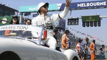 In this March 17, 2019, file photo, Mercedes driver Lewis Hamilton of Britain waves as the drivers parade begins ahead of the Australian Grand Prix in Melbourne, Australia.