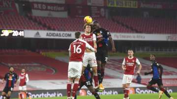 Arsenal's David Luiz, center, jumps for the ball with Crystal Palace's Christian Benteke.