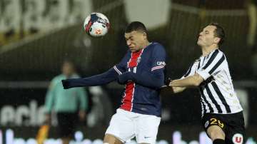 PSG's Kylian Mbappe, left, duels for the ball with Angers' Vincent Manceau during the French League One soccer match between Angers and Paris Saint-Germain at Jean-Bouin stadium in Angers, France, Saturday, Jan. 16