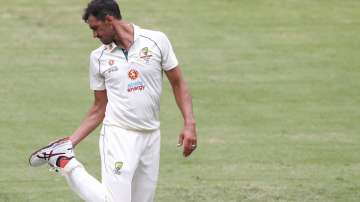 Australian bowler Mitchell Starc checks his boot during play on day three of the fourth cricket test between India and Australia at the Gabba, Brisbane