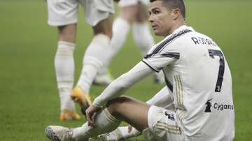 Juventus' Cristiano Ronaldo sits on the ground during a Serie A soccer match between Inter Milan and Juventus at the San Siro stadium in Milan, Italy, Sunday, Jan. 17