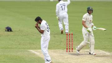 India's Shardul Thakur, left, celebrates the dismissal of Australia's Tim Paine, right, during play on day four of the fourth cricket test between India and Australia at the Gabba, Brisbane, Australia, Monday, Jan. 18