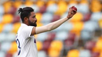 India's Mohammed Siraj gestures with the ball as he leaves the field after taking five wickets during play on day four of the fourth cricket test between India and Australia at the Gabba, Brisbane, Australia, Monday, Jan. 18