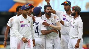 India's Mohammed Siraj, centre, is congratulated by teammates after taking his fifth wicket during play on day four of the fourth cricket test between India and Australia at the Gabba, Brisbane, Australia, Monday, Jan. 18