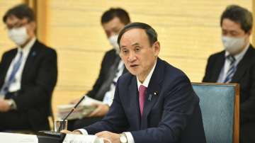 Japanese Prime Minister Yoshihide Suga speaks during a meeting of the coronavirus infection control headquarters at his office in Tokyo Friday, Jan. 22