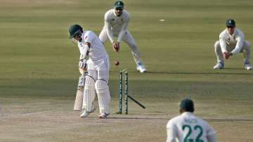 Pakistan's batsman Abid Ali, center, is bowled out by South Africa's pacer Kagiso Rabada during the first day of the first cricket test match between Pakistan and South Africa at the National Stadium, in Karachi, Pakistan, Tuesday, Jan. 26