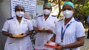 With 'arti' thalis and sweets health workers at Mumbai hospital cheer as vaccines arrive
