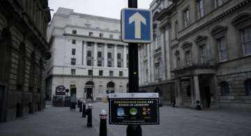 A coronavirus safety advice sign is displayed in the City of London financial district in London, Jan. 5, 2021, on the first morning of England entering a third national lockdown since the coronavirus outbreak began. 
