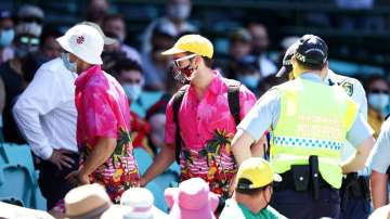 Police speak to spectators following a complaint from Mohammed Siraj of India that stopped play during day four of the Third Test match in the series between Australia and India at Sydney Cricket Ground on January 10