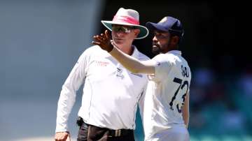 Mohammed Siraj of India stops play to make a formal complaint to Umpire Paul Reiffel about some spectators in the bay behind his fielding position during day four of the Third Test match in the series between Australia and India at Sydney Cricket Ground on January 10